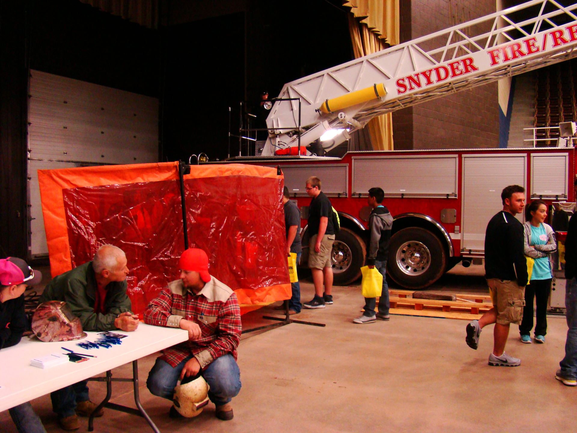 Individuals at welding booth.
